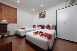 Postel nebo postele na pokoji v ubytování Hanoi Aria Central Hotel & Spa