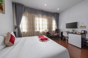 Postel nebo postele na pokoji v ubytování Hanoi Aria Central Hotel & Spa
