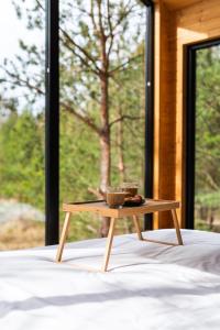 a wooden coffee table sitting on top of a bed at Forestic Lietuva in Vilionys