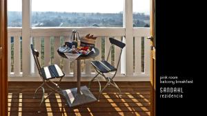 a table with a bowl of food on a balcony at Sandahl Rezidencia in Badacsonytomaj