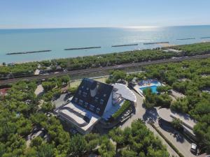 an aerial view of a resort with a pool and the ocean at Camping Led Zeppelin in Cupra Marittima