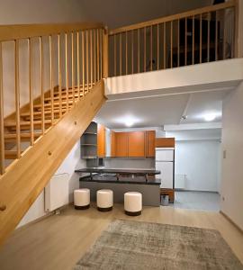 a large kitchen with a staircase in a house at EQbase Vienna City Apartments in Vienna