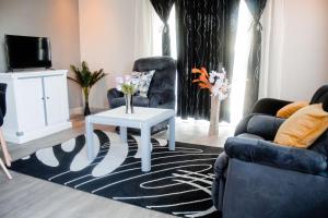 a living room with a couch and a table at Cozy Livin - Duplex in Maseru