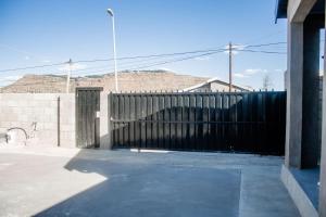 a black fence in front of a house at Cozy Livin - Duplex in Maseru