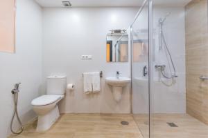 a bathroom with a toilet and a sink and a shower at El Nogal Home in Málaga