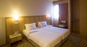 Cama ou camas em um quarto em Hotel Santo Andre