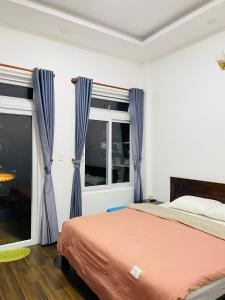 a bedroom with a bed and a window at Trà duyên Homestay in Da Lat +12 photos