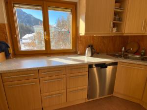 a kitchen with a window and a sink and a dishwasher at Residenz Maroi - Wasle in Sankt Anton am Arlberg +34 photos