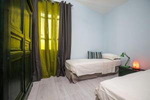 Postel nebo postele na pokoji v ubytování GGHH House Hotel