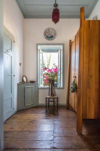a room with a window and a wooden floor at Villa Melograno HALKI in Halki