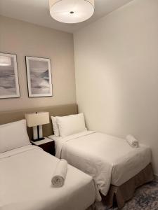 a hotel room with two beds and a lamp at Address Beach Resort Fujairah - AU 79 CODE in Sharm +43 photos