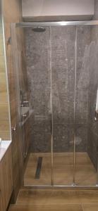 a shower with a glass door in a bathroom at Apartman A2-3 u Apart hotel Vučko in Jahorina
