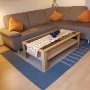 a living room with a couch and a coffee table at Appartement Lübeck St. Lorenz in Lübeck