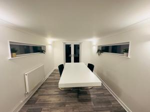 a white table and chairs in a room at Comfortable Double Rooms in a Beautiful House in Ipswich +68 photos