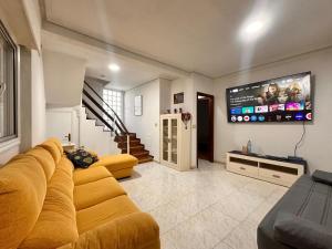 a living room with a couch and a flat screen tv at Casa Independiente en Quintela - HomeyGalicia in Vigo