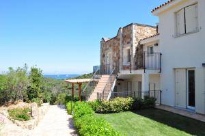 a villa with a view of the ocean at Baia Bianca Apartments Sardinia in Baja Sardinia