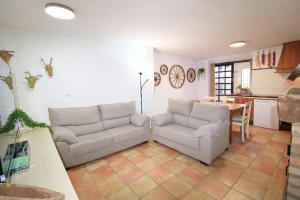 ein Wohnzimmer mit zwei Sofas und einem Tisch in der Unterkunft La Casa de la Tierra by SIERRA VIVA in Los Marines