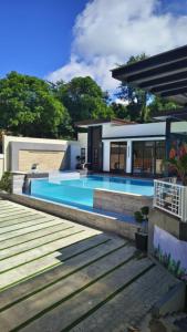 a house with a swimming pool next to a house at Villa Luminous Private Resort in Upi