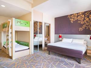 A bed or beds in a room at Ibis Styles Malang