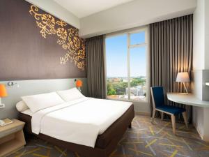 A bed or beds in a room at Ibis Styles Malang