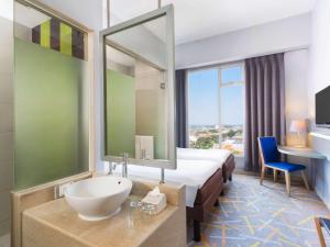 A bed or beds in a room at Ibis Styles Malang
