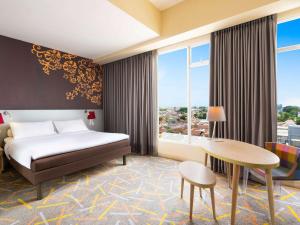A bed or beds in a room at Ibis Styles Malang