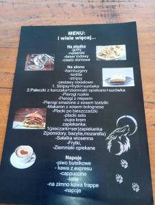 a menu for a restaurant on a table at Domek Wilcza Wola 2 in Górzanka