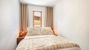 a bedroom with a bed and a window at Les Fermes de Saint Sorlin H 103 - 2P6 in Saint-Sorlin-dʼArves