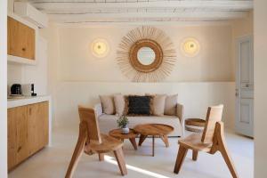 a living room with a couch and a table and chairs at Aerina Residences in Platis Gialos