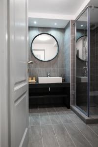a bathroom with a sink and a mirror at Pensiunea Pyramia in Gura Humorului +15 photos
