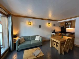 a living room with a couch and a table at L’Aster in Lanslebourg-Mont-Cenis +3 photos