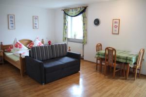 a living room with a couch and a table at Pension & Ferienwohnung Breitmoser Angelika in Riedenburg