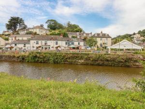 a town next to a river with buildings at Josie in St Austell