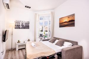 a bedroom with a bed in a room with a window at Main Street Suite & Views , by CartagenaSpain in Cartagena