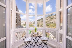 a room with a table and chairs and a large window at Main Street Suite & Views , by CartagenaSpain in Cartagena