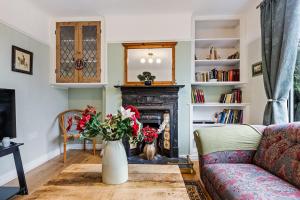 a living room with a couch and a fireplace at Pass the Keys Lovely Home in York with Parking in York