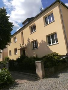 a yellow house with a fence in front of it at Zum-Rudi in Halberstadt