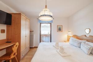 Postel nebo postele na pokoji v ubytování Albergo Vezzana