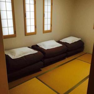 En eller flere senge i et værelse på あり宿 USJ&万博 大阪西九条駅 Ariyado USJ&EXPO Osaka Nishikujo