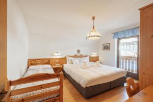 Postel nebo postele na pokoji v ubytování Albergo Vezzana