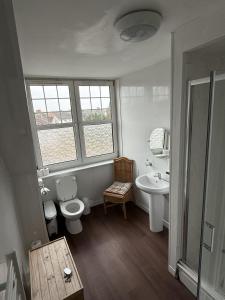 a bathroom with a toilet and a sink at Gothenburg Hotel in Rosyth