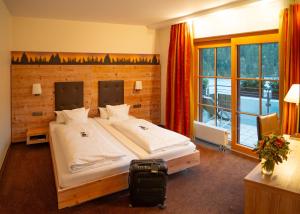 Postel nebo postele na pokoji v ubytování Berghotel Mummelsee