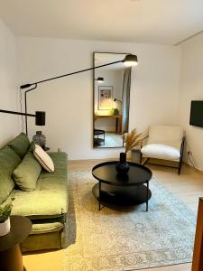 a living room with a couch and a table at EQbase Vienna City Apartments in Vienna