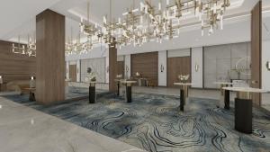 a rendering of a lobby with tables and a chandelier at voco Jeddah Gate by IHG in Jeddah