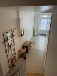 a hallway with a stairway with a box on it at Maison de ville avec terrasse in La Rochelle