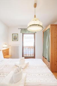Postel nebo postele na pokoji v ubytování Albergo Vezzana