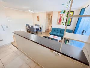 a living room with a couch and a table at Amplio y Cómodo departamento in Temuco +17 photos