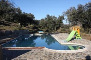 a small swimming pool with a slide in a park at Cortijo El Criadero in El Hoyo