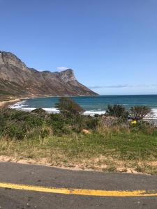 a view of a beach with the ocean at Awesome room in surf house in Hermanus +28 photos