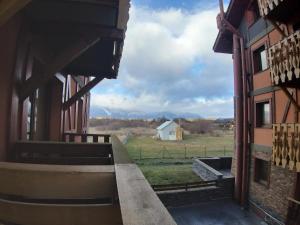 a view from the inside of a building with a view of a field at Apartmán pod Tatrami B207 in Veľká Lomnica
